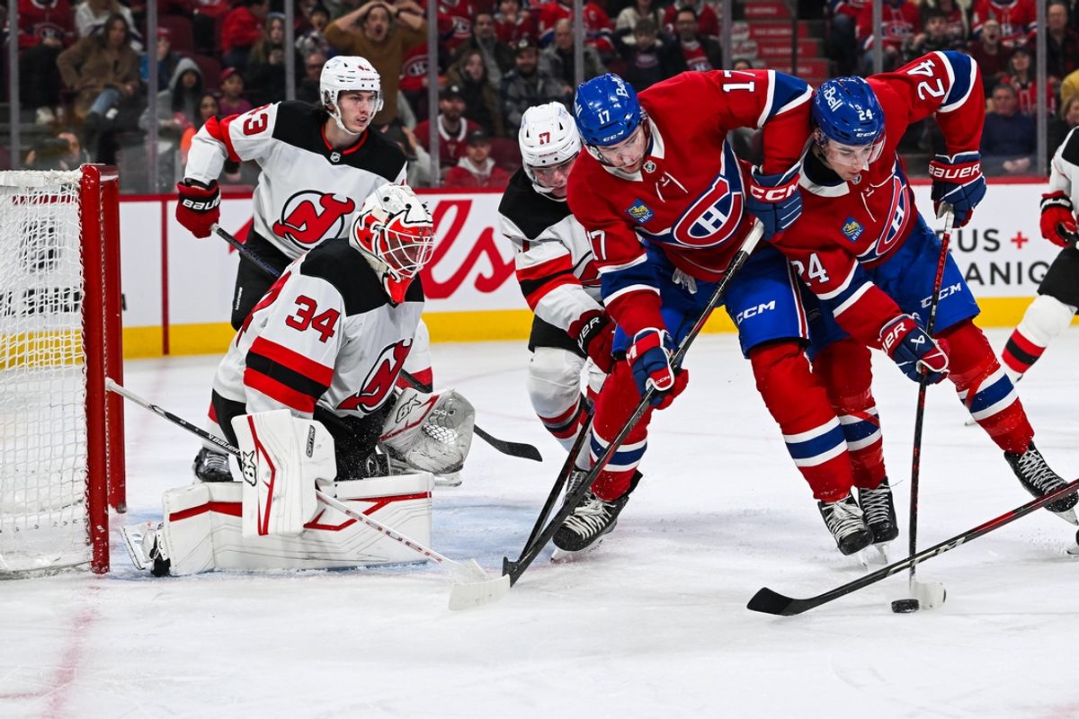 Feb 8, 2025; Montreal, Quebec, CAN; Montreal Canadiens defenseman Logan Mailloux (24) plays the puck beside right wing Josh Anderson (17) against New Jersey Devils goalie Jake Allen (34) during the second period at Bell Centre. Mandatory Credit: David Kirouac-Imagn Images