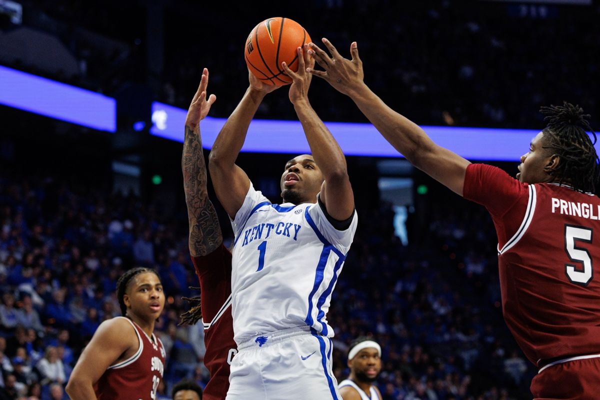 Feb 8, 2025; Lexington, Kentucky, USA; Kentucky Wildcats guard Lamont Butler (1) shoots the ball against South Carolina Gamecocks guard Jamarii Thomas (6) and forward Nick Pringle (5) during the second half at Rupp Arena at Central Bank Center. Mandatory Credit: Jordan Prather-Imagn Images