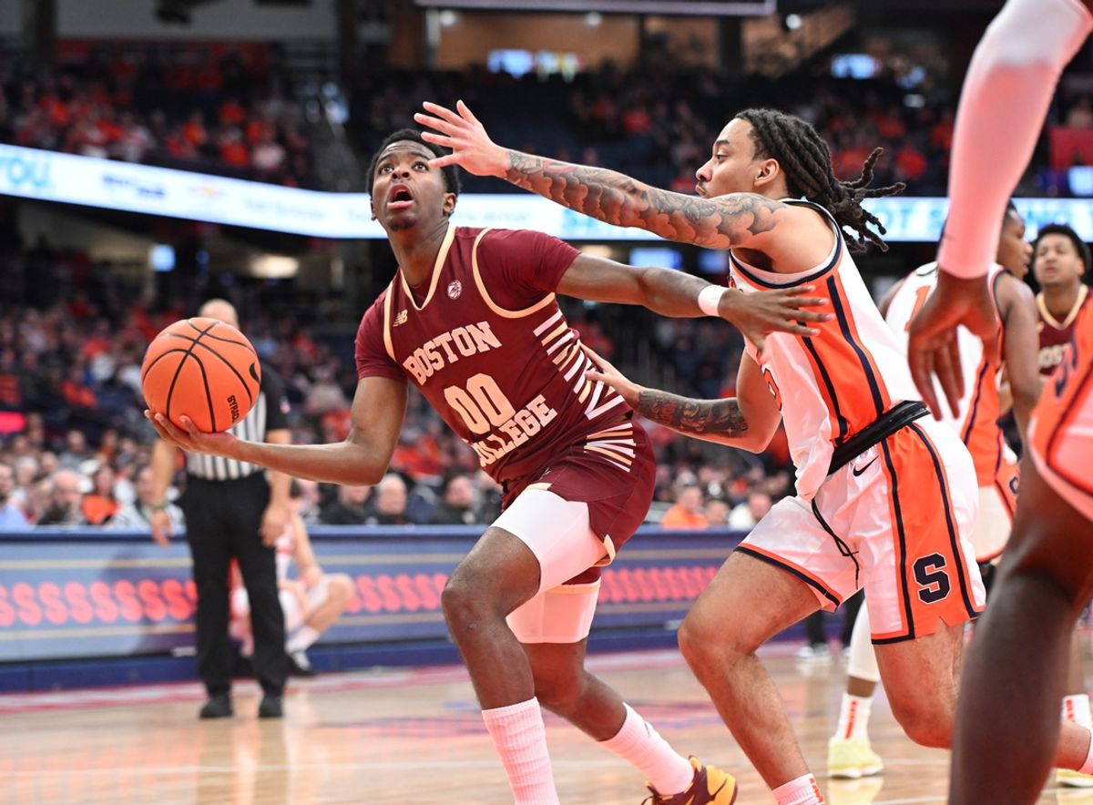 Feb 8, 2025; Syracuse, New York, USA; Boston College Eagles guard Chas Kelley III (00) looks to the basket to take a shot against Syracuse Orange guard Jaquan Carlos (5) in the first half at the JMA Wireless Dome. Mandatory Credit: Mark Konezny-Imagn Images