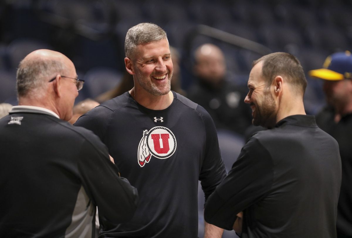 Feb 8, 2025; Morgantown, West Virginia, USA; Utah Utes assistant coach Josh Eilert talks with West Virginia University Athletic Director Wren Baker before their game at WVU Coliseum. Mandatory Credit: Ben Queen-Imagn Images