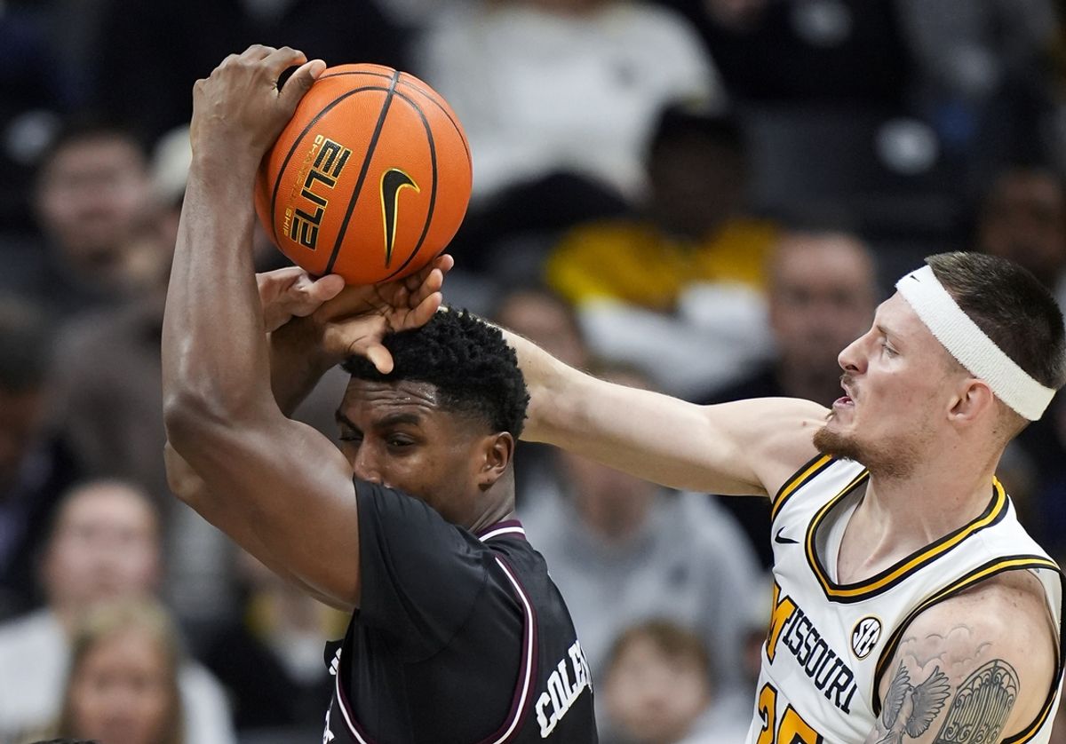 Feb 8, 2025; Columbia, Missouri, USA; Texas A&M Aggies forward Henry Coleman III (15) loses control of the ball as Missouri Tigers guard Jacob Crews (35) defends during the first half at Mizzou Arena. Mandatory Credit: Jay Biggerstaff-Imagn Images