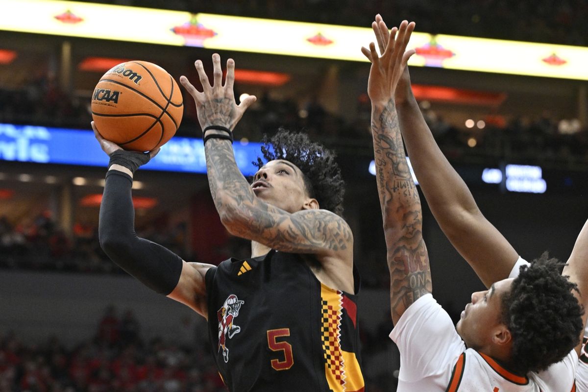 Feb 8, 2025; Louisville, Kentucky, USA;  Louisville Cardinals guard Terrence Edwards Jr. (5) shoots against Miami (Fl) Hurricanes guard Jalil Bethea (3) during the second half at KFC Yum! Center. Louisville defeated Miami 88-78. Mandatory Credit: Jamie Rhodes-Imagn Images