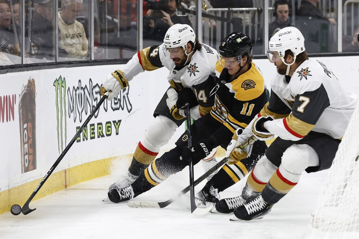 Feb 8, 2025; Boston, Massachusetts, USA; Vegas Golden Knights defenseman Nicolas Hague (14) and defenseman Alex Pietrangelo (7) try to keep Boston Bruins center Trent Frederic (11) from the puck during the first period at TD Garden. Mandatory Credit: Winslow Townson-Imagn Images