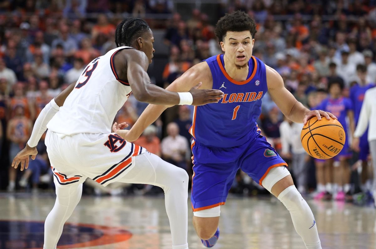 Feb 8, 2025; Auburn, Alabama, USA;  Florida Gators guard Walter Clayton Jr. (1) runs a play as Auburn Tigers guard Miles Kelly (13) defends during the first half at Neville Arena. Mandatory Credit: John Reed-Imagn Images