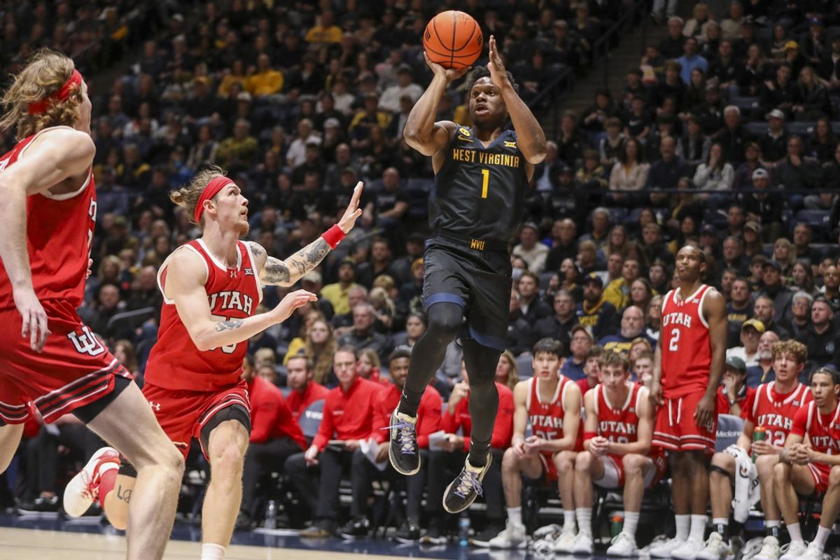 Feb 8, 2025; Morgantown, West Virginia, USA; West Virginia Mountaineers guard Joseph Yesufu (1) shoots over Utah Utes guard Gabe Madsen (55) during the first half at WVU Coliseum. Mandatory Credit: Ben Queen-Imagn Images