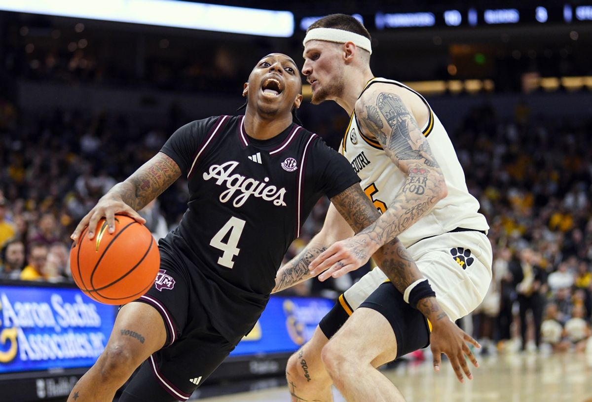 Feb 8, 2025; Columbia, Missouri, USA; Texas A&M Aggies guard Wade Taylor IV (4) drives against Missouri Tigers guard Jacob Crews (35) during the second half at Mizzou Arena. Mandatory Credit: Jay Biggerstaff-Imagn Images