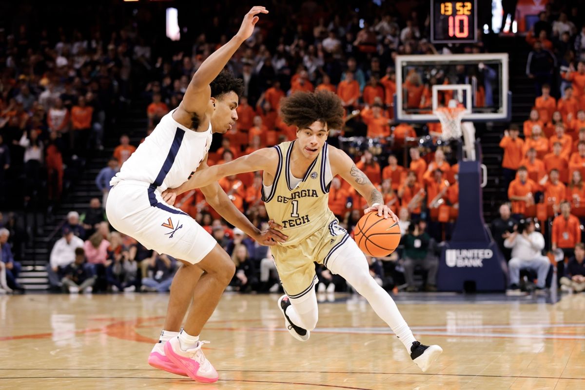 Feb 8, 2025; Charlottesville, Virginia, USA; Georgia Tech Yellow Jackets guard Naithan George (1) dribbles the ball while Virginia Cavaliers forward Anthony Robinson (21) defends in the first half at John Paul Jones Arena. Mandatory Credit: Amber Searls-Imagn Images