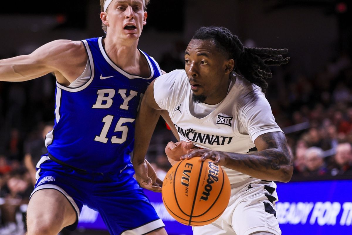 Feb 8, 2025; Cincinnati, Ohio, USA; Cincinnati Bearcats guard Day Day Thomas (1) dribbles against Brigham Young Cougars forward Richie Saunders (15) in the first half at Fifth Third Arena. Mandatory Credit: Katie Stratman-Imagn Images