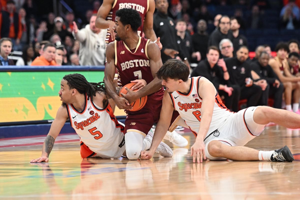 Feb 8, 2025; Syracuse, New York, USA; Syracuse Orange guard Jaquan Carlos (left) and forward Petar Majstorovic (6) with Boston College Eagles guard Joshua Beadle (7) look to see the call for the ball in the second overtime period at the JMA Wireless Dome. Mandatory Credit: Mark Konezny-Imagn Images