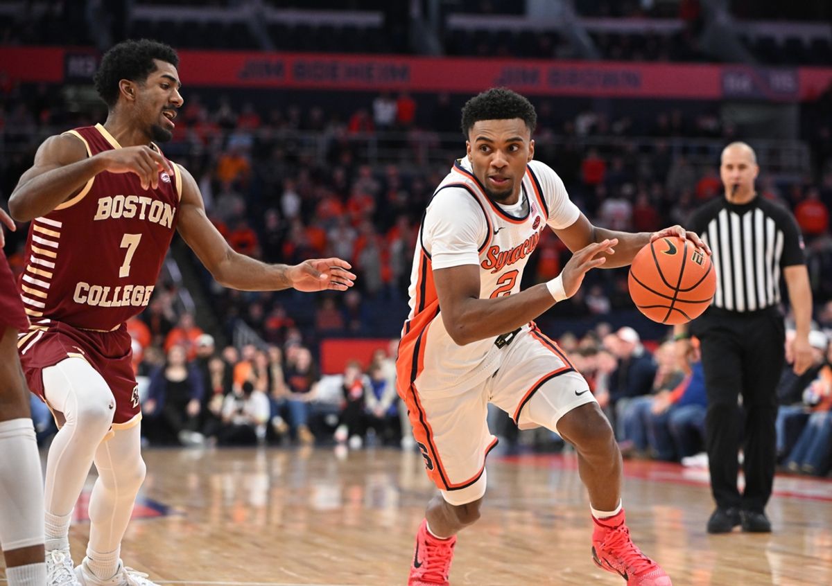 Feb 8, 2025; Syracuse, New York, USA; Syracuse Orange guard J.J. Starling (2) drives the ball as Boston College Eagles guard Joshua Beadle (7) defends in the third overtime period at the JMA Wireless Dome. Mandatory Credit: Mark Konezny-Imagn Images