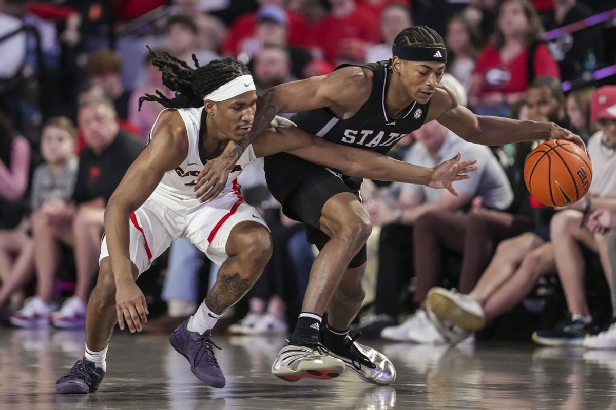 Feb 8, 2025; Athens, Georgia, USA; Georgia Bulldogs guard Silas Demary Jr. (5) tries to steal the ball from Mississippi State Bulldogs guard Shawn Jones Jr. (5) during the first half at Stegeman Coliseum. Mandatory Credit: Dale Zanine-Imagn Images