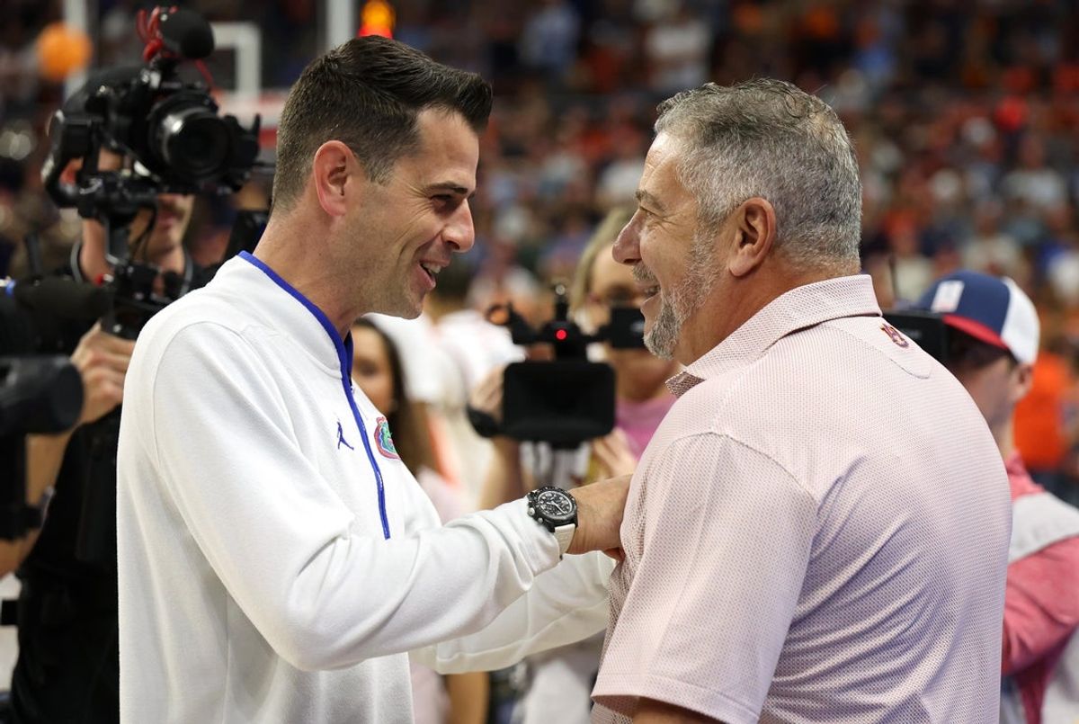 Feb 8, 2025; Auburn, Alabama, USA;  Florida Gators head coach Todd Golden talks with Auburn Tigers head coach Bruce Pearl before their game at Neville Arena. Mandatory Credit: John Reed-Imagn Images