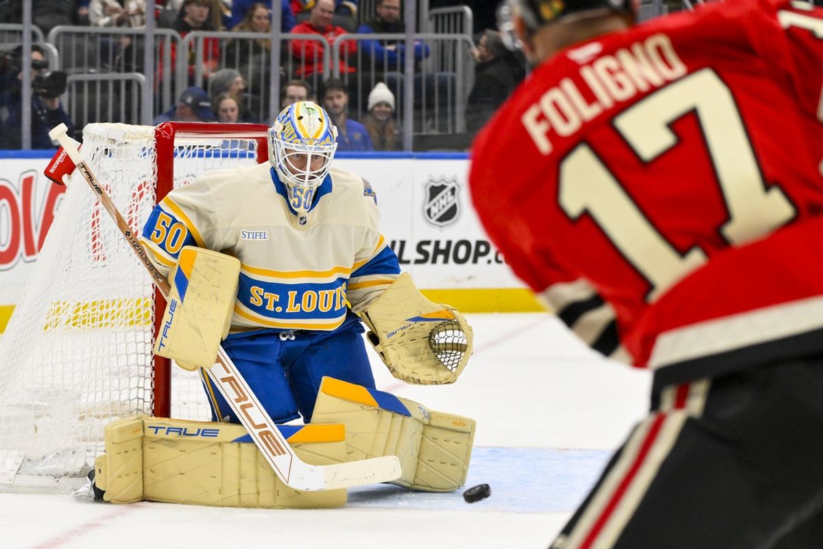 Feb 8, 2025; St. Louis, Missouri, USA;  St. Louis Blues goaltender Jordan Binnington (50) defends the net against Chicago Blackhawks left wing Nick Foligno (17) during the first period at Enterprise Center. Mandatory Credit: Jeff Curry-Imagn Images