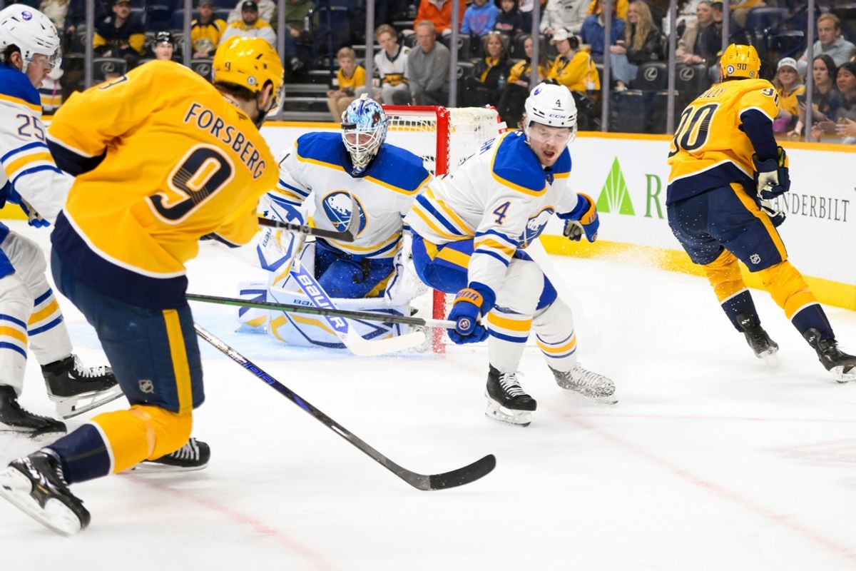 Feb 8, 2025; Nashville, Tennessee, USA;  Buffalo Sabres goaltender Ukko-Pekka Luukkonen (1) blocks a shot by Nashville Predators left wing Filip Forsberg (9) during the first period at Bridgestone Arena. Mandatory Credit: Steve Roberts-Imagn Images