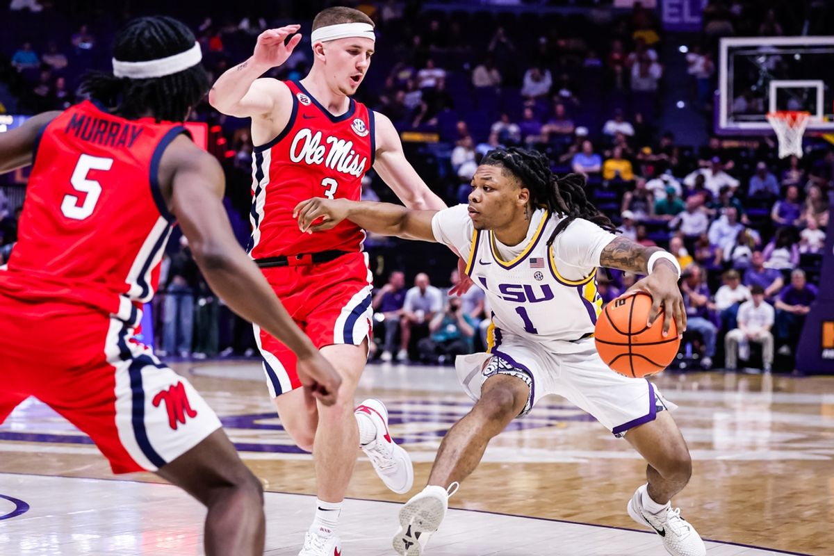 Feb 8, 2025; Baton Rouge, Louisiana, USA; LSU Tigers guard Jordan Sears (1) dribbles against Mississippi Rebels guard Sean Pedulla (3) during the first half at Pete Maravich Assembly Center. Mandatory Credit: Stephen Lew-Imagn Images