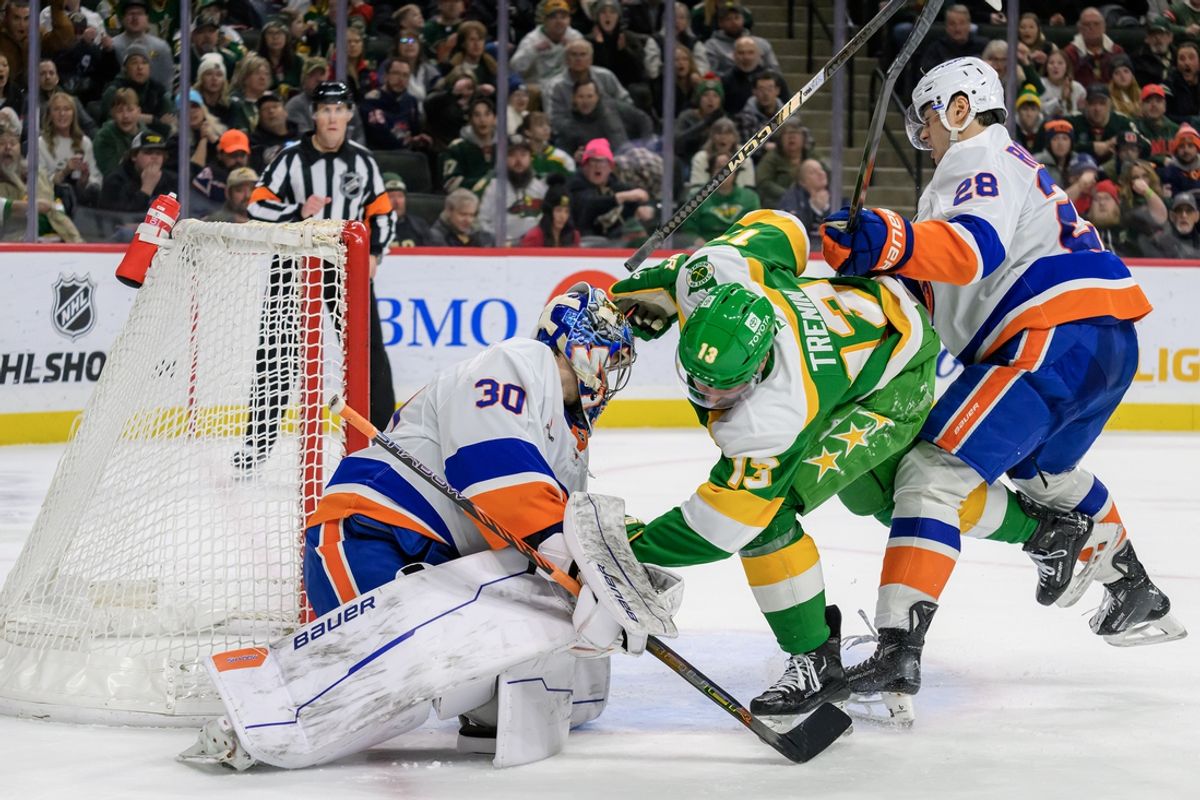 Feb 8, 2025; Saint Paul, Minnesota, USA;  Minnesota Wild forward Yakov Trenin (13) scores a goal on New York Islanders goalie Ilya Sorokin (30) as defenseman Alexander Romanov (28) defends during the second period at Xcel Energy Center. Mandatory Credit: Nick Wosika-Imagn Images