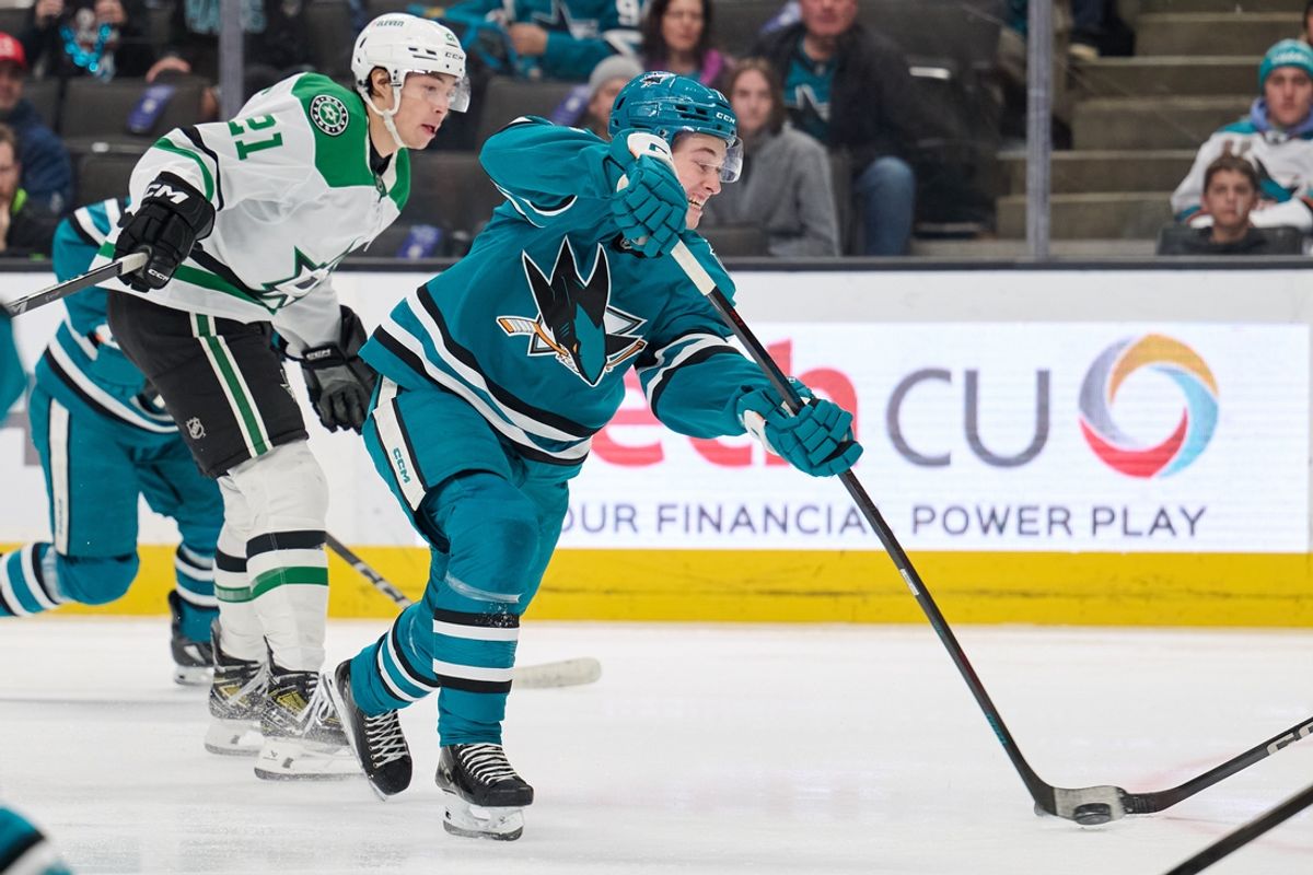 Feb 8, 2025; San Jose, California, USA; San Jose Sharks center Macklin Celebrini (71) shoots against Dallas Stars left wing Jason Robertson (21) during the first period at SAP Center at San Jose. Mandatory Credit: Robert Edwards-Imagn Images
