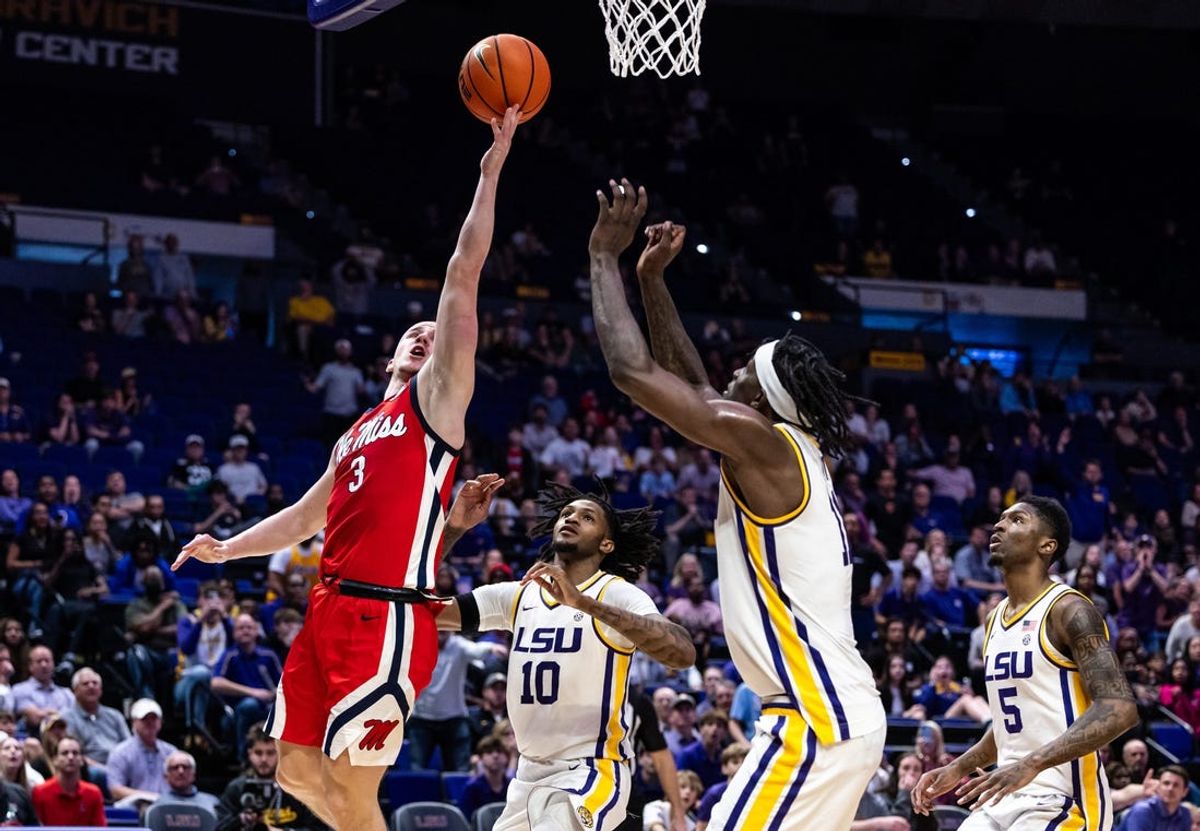 Feb 8, 2025; Baton Rouge, Louisiana, USA;  Mississippi Rebels guard Sean Pedulla (3) drives to the basket against LSU Tigers forward Daimion Collins (10) for the game winning basket during the second half at Pete Maravich Assembly Center. Mandatory Credit: Stephen Lew-Imagn Images