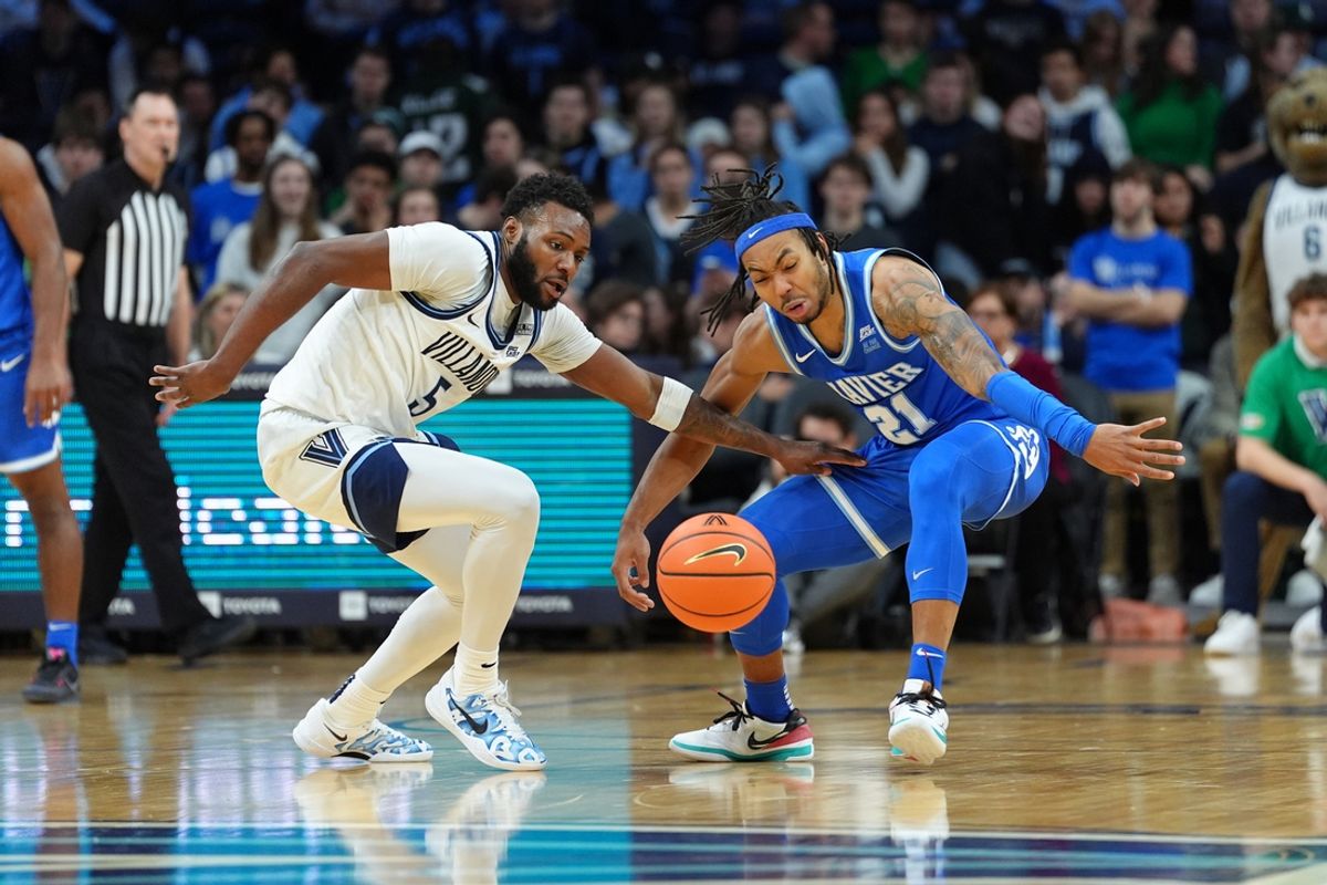 Feb 9, 2025; Philadelphia, Pennsylvania, USA; Villanova Wildcats guard Wooga Poplar (5) and Xavier Musketeers guard Dante Maddox Jr (21) battle for the ball in the first half at Wells Fargo Center. Mandatory Credit: Kyle Ross-Imagn Images