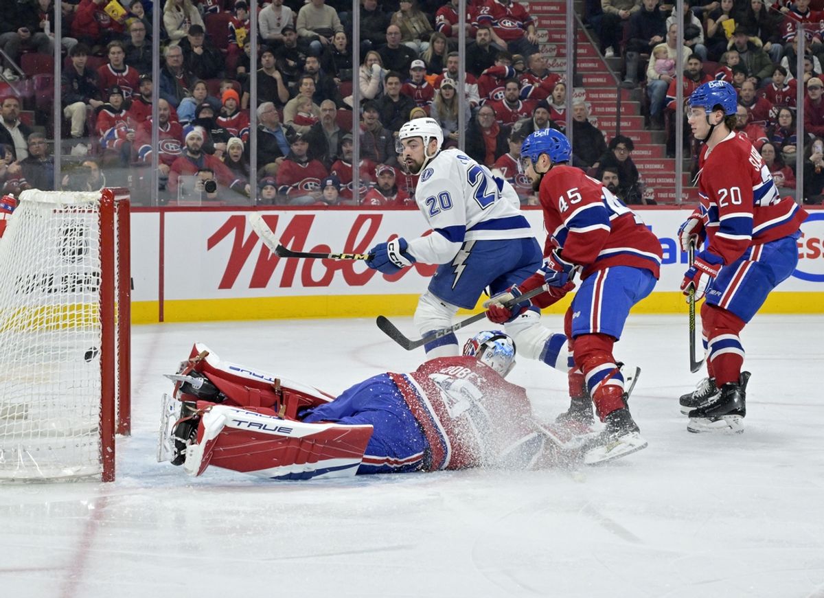Feb 9, 2025; Montreal, Quebec, CAN; Tampa Bay Lightning forward Nicholas Paul (20) scores a goal against Montreal Canadiens goalie Jakub Dobes (75) during the first period at the Bell Centre. Mandatory Credit: Eric Bolte-Imagn Images