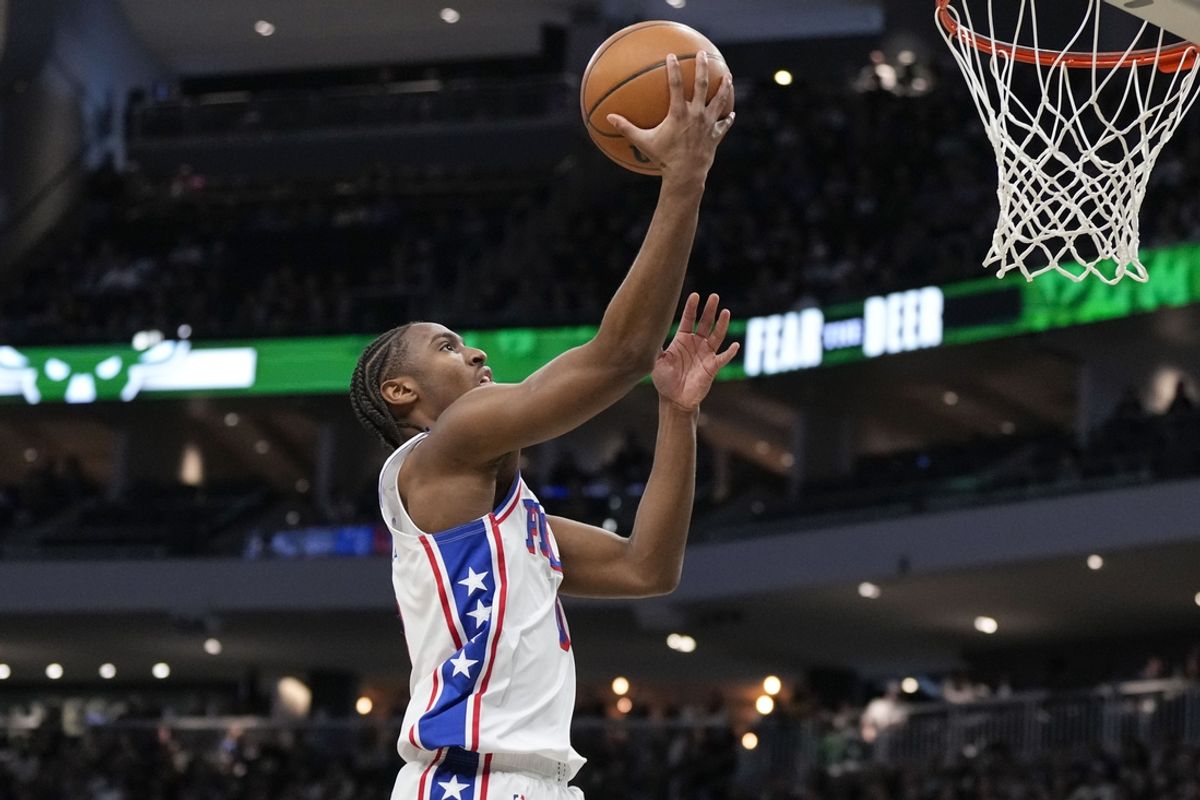 Feb 9, 2025; Milwaukee, Wisconsin, USA;  Philadelphia 76ers guard Tyrese Maxey (0) drives for a layup during the first quarter against the Milwaukee Bucks at Fiserv Forum. Mandatory Credit: Jeff Hanisch-Imagn Images