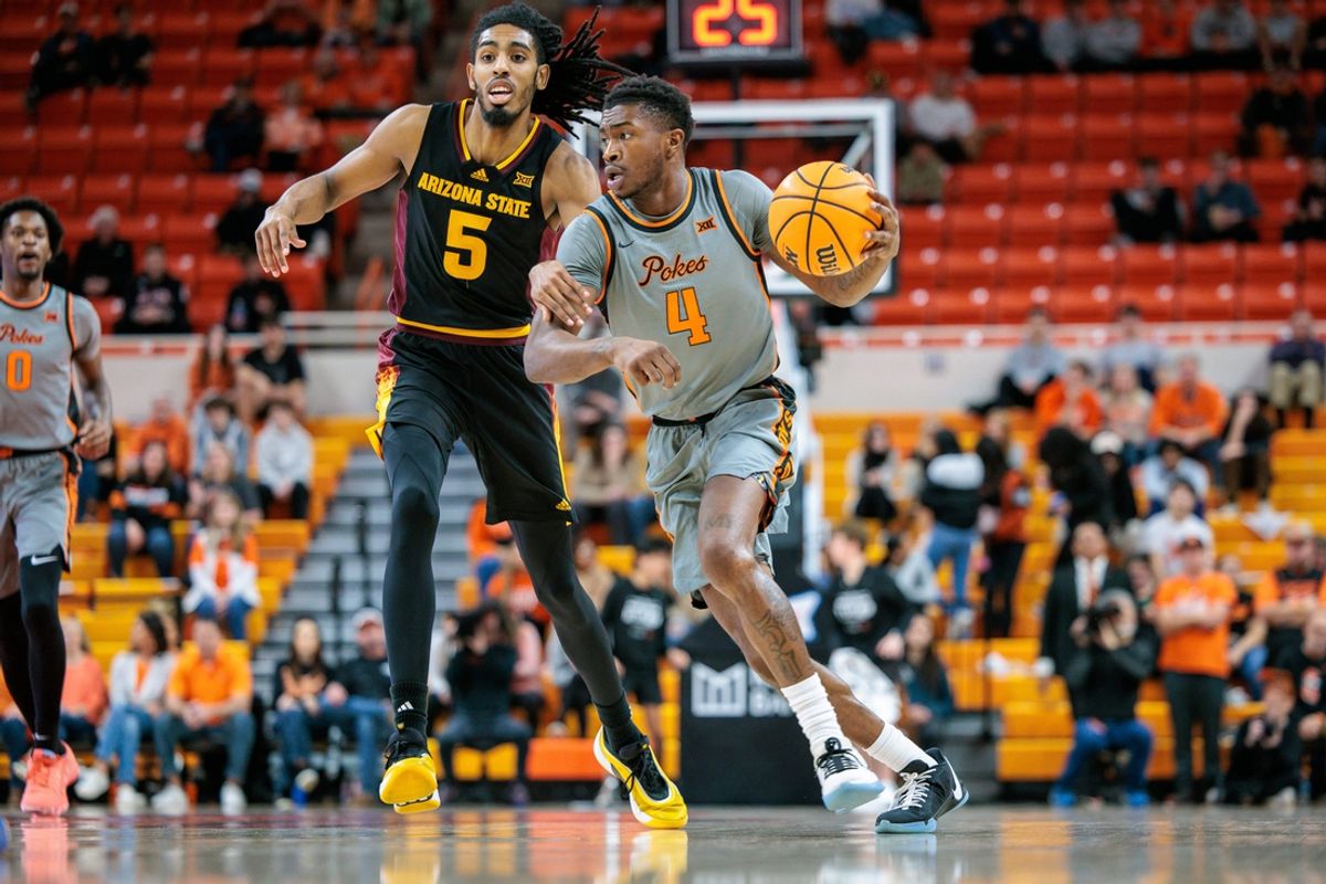 Feb 9, 2025; Stillwater, Oklahoma, USA;  Oklahoma State Cowboys guard Davonte Davis (4) drives to the basket around Arizona State Sun Devils guard Amier Ali (5) during the first half at Gallagher-Iba Arena. Mandatory Credit: William Purnell-Imagn Images