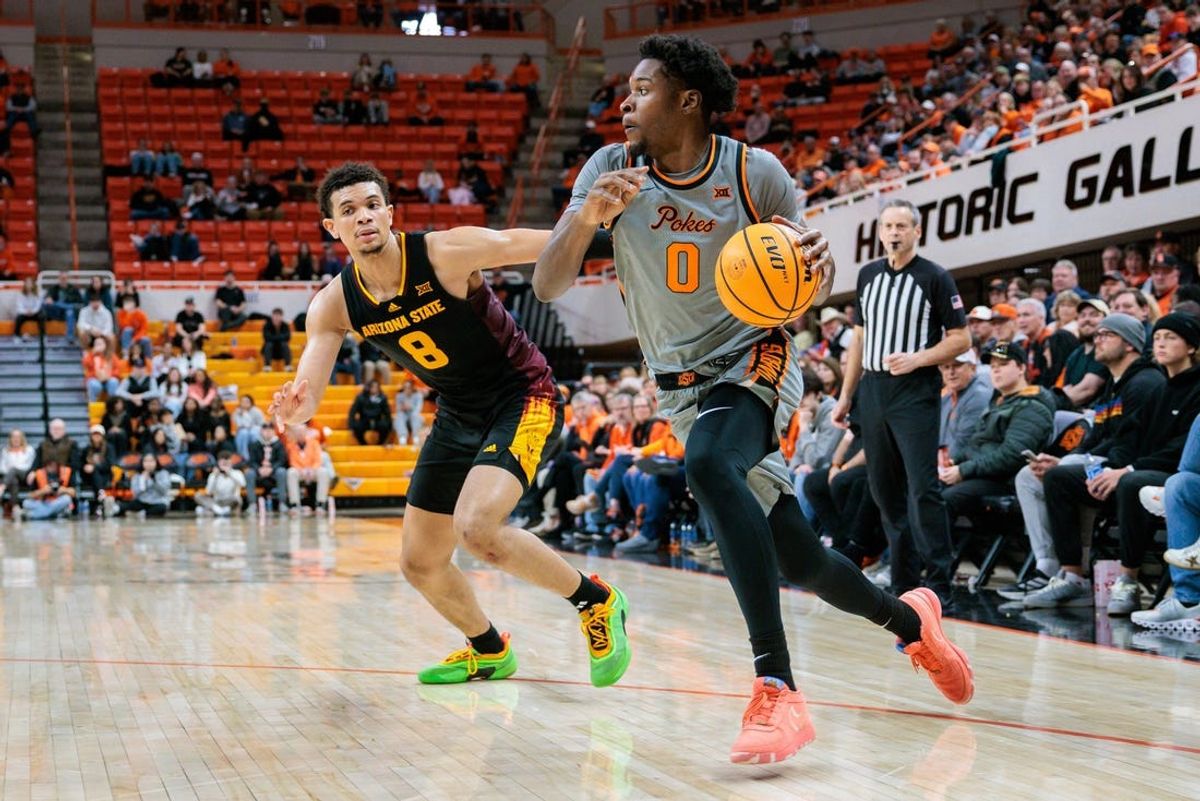 Feb 9, 2025; Stillwater, Oklahoma, USA;  Oklahoma State Cowboys forward Marchelus Avery (0) drives to the basket around Arizona State Sun Devils forward Basheer Jihad (8) during the first half at Gallagher-Iba Arena. Mandatory Credit: William Purnell-Imagn Images