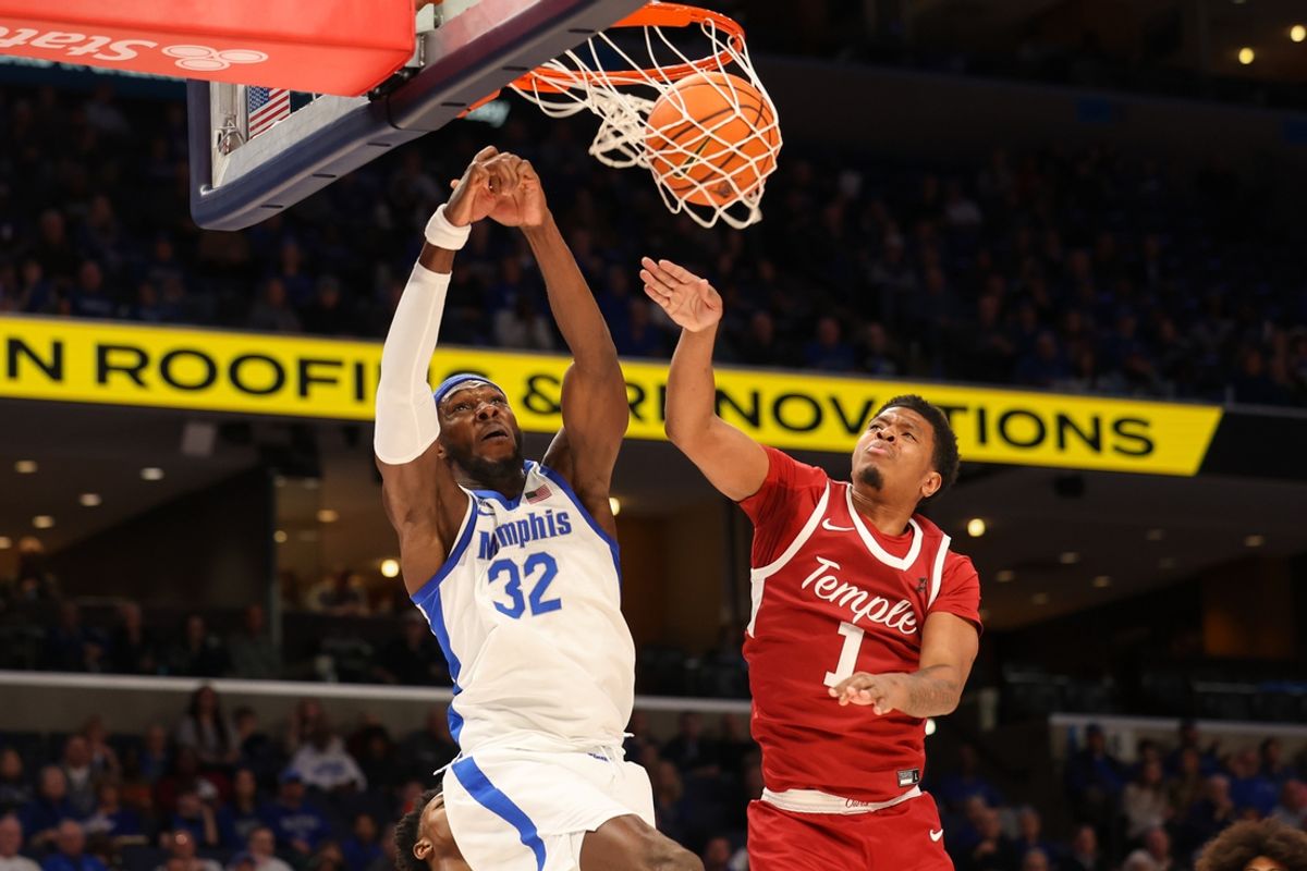 Feb 9, 2025; Memphis, Tennessee, USA; Memphis Tigers center Moussa Cisse (32) dunks the ball against Temple Owls guard Zion Stanford (1) during the first half at FedExForum. Mandatory Credit: Wesley Hale-Imagn Images