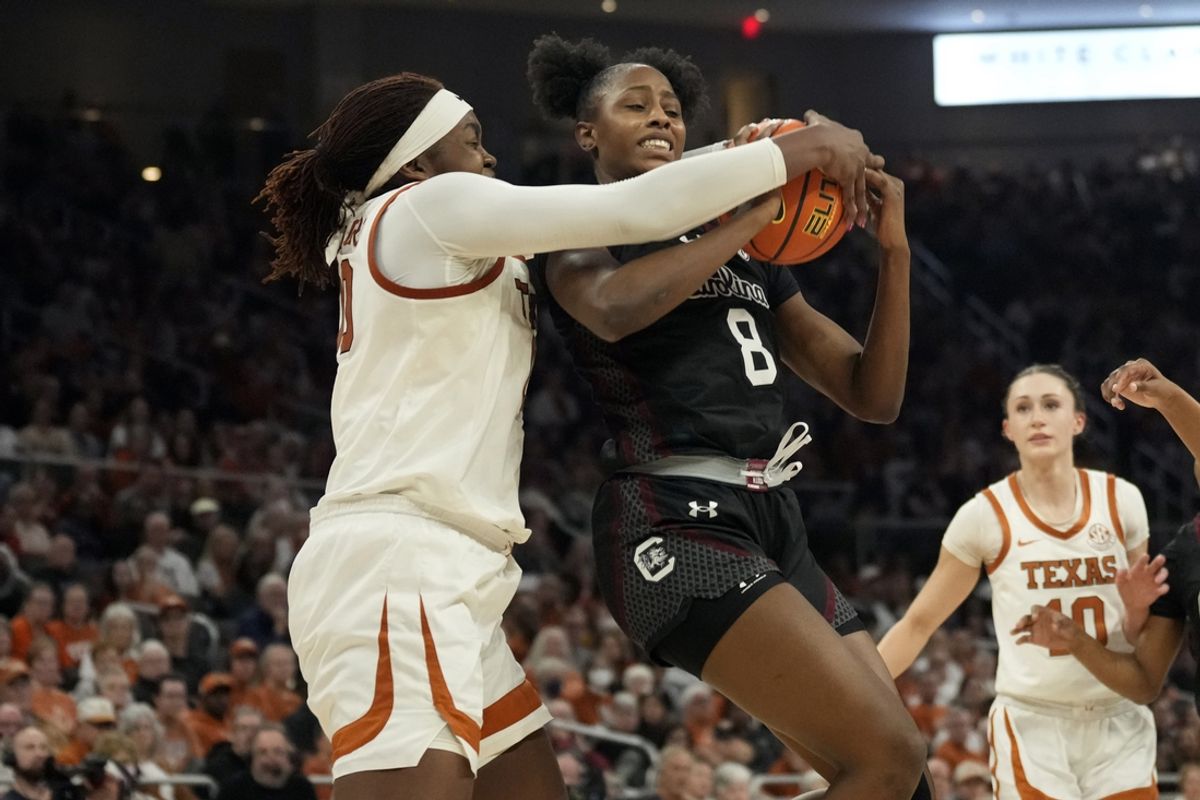 Feb 9, 2025; Austin, Texas, USA; South Carolina Gamecocks forward Joyce Edwards (8) and Texas Longhorns center Kyla Oldacre (00) battle for a rebound during the second half at Moody Center. Mandatory Credit: Scott Wachter-Imagn Images