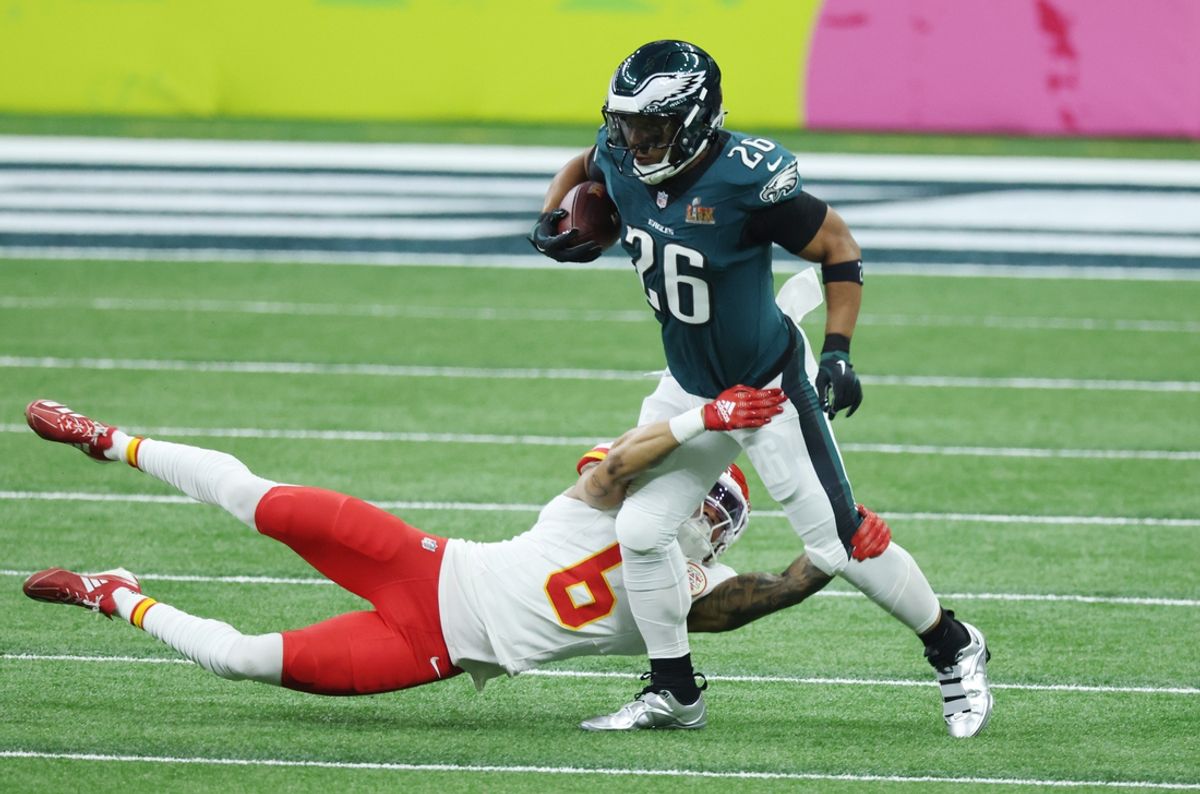 Feb 9, 2025; New Orleans, LA, USA; Philadelphia Eagles running back Saquon Barkley (26) runs the ball against Kansas City Chiefs safety Bryan Cook (6) in the first quarter in Super Bowl LIX at Ceasars Superdome. Mandatory Credit: Stephen Lew-Imagn Images