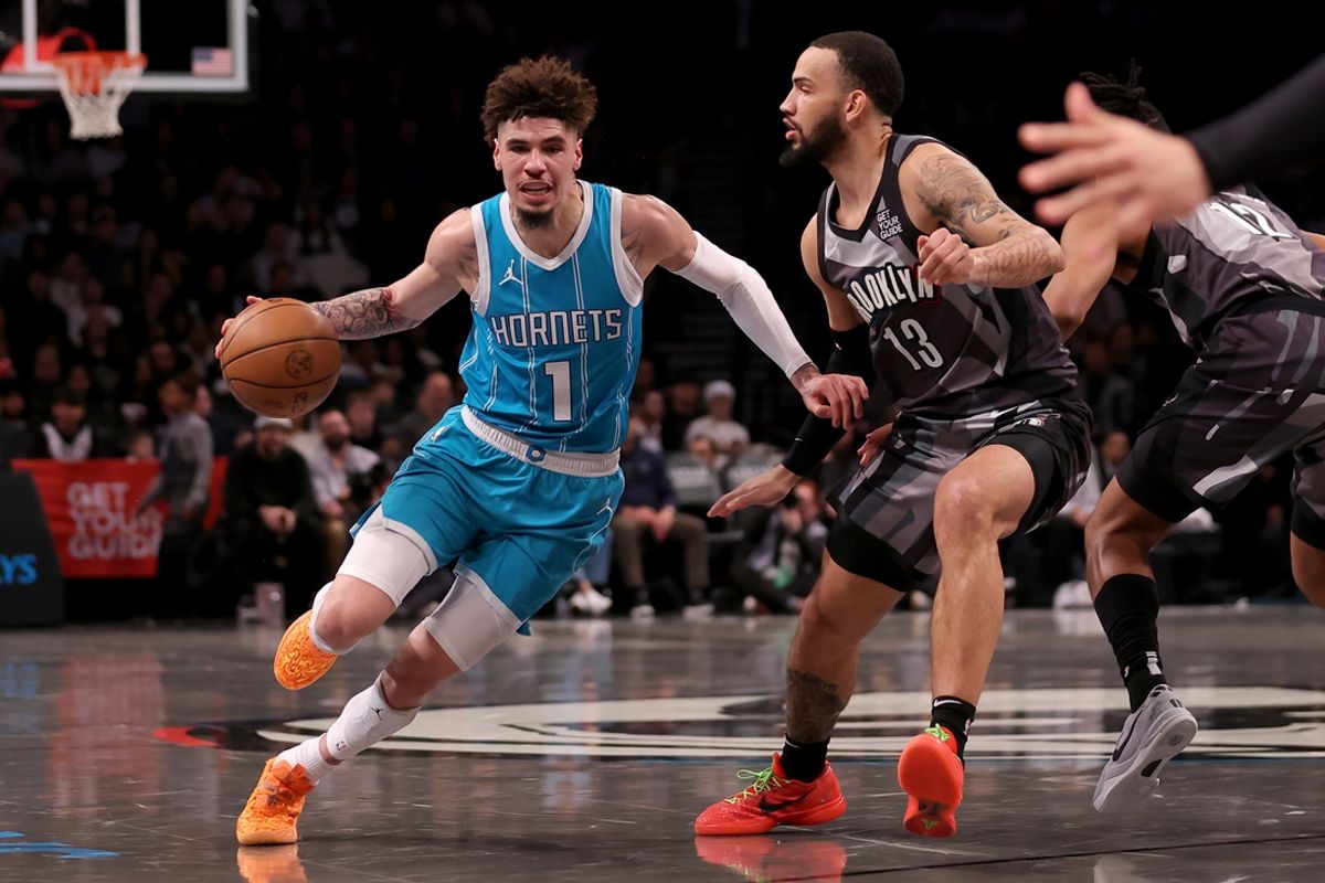 Feb 10, 2025; Brooklyn, New York, USA; Charlotte Hornets guard LaMelo Ball (1) drives around Brooklyn Nets guard Tyrese Martin (13) during the first quarter at Barclays Center. Mandatory Credit: Brad Penner-Imagn Images