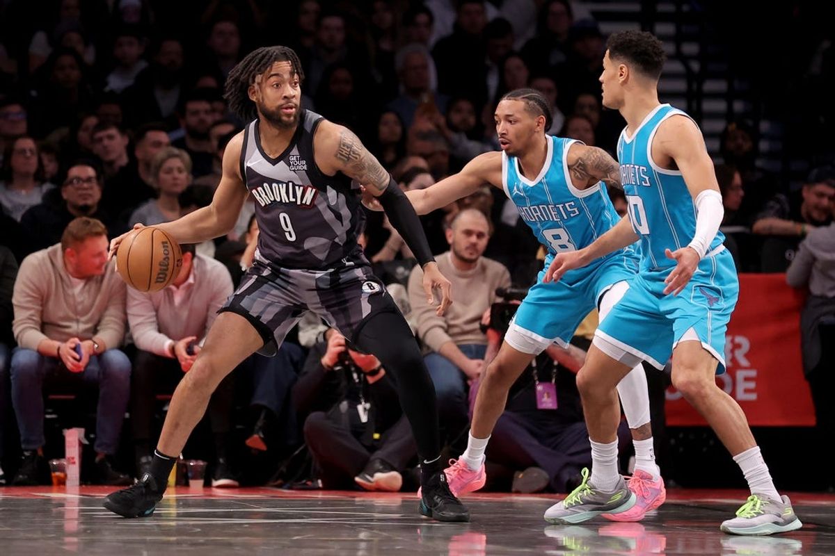 Feb 10, 2025; Brooklyn, New York, USA; Brooklyn Nets forward Trendon Watford (9) controls the ball against Charlotte Hornets guards Nick Smith Jr. (8) and Josh Green (10) during the second quarter at Barclays Center. Mandatory Credit: Brad Penner-Imagn Images