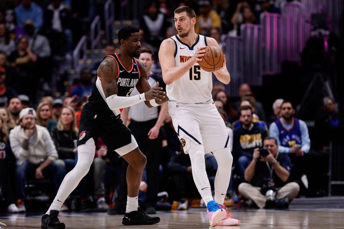 Feb 10, 2025; Denver, Colorado, USA; Denver Nuggets center Nikola Jokic (15) controls the ball as Portland Trail Blazers center Deandre Ayton (2) guards in the first quarter at Ball Arena. Mandatory Credit: Isaiah J. Downing-Imagn Images