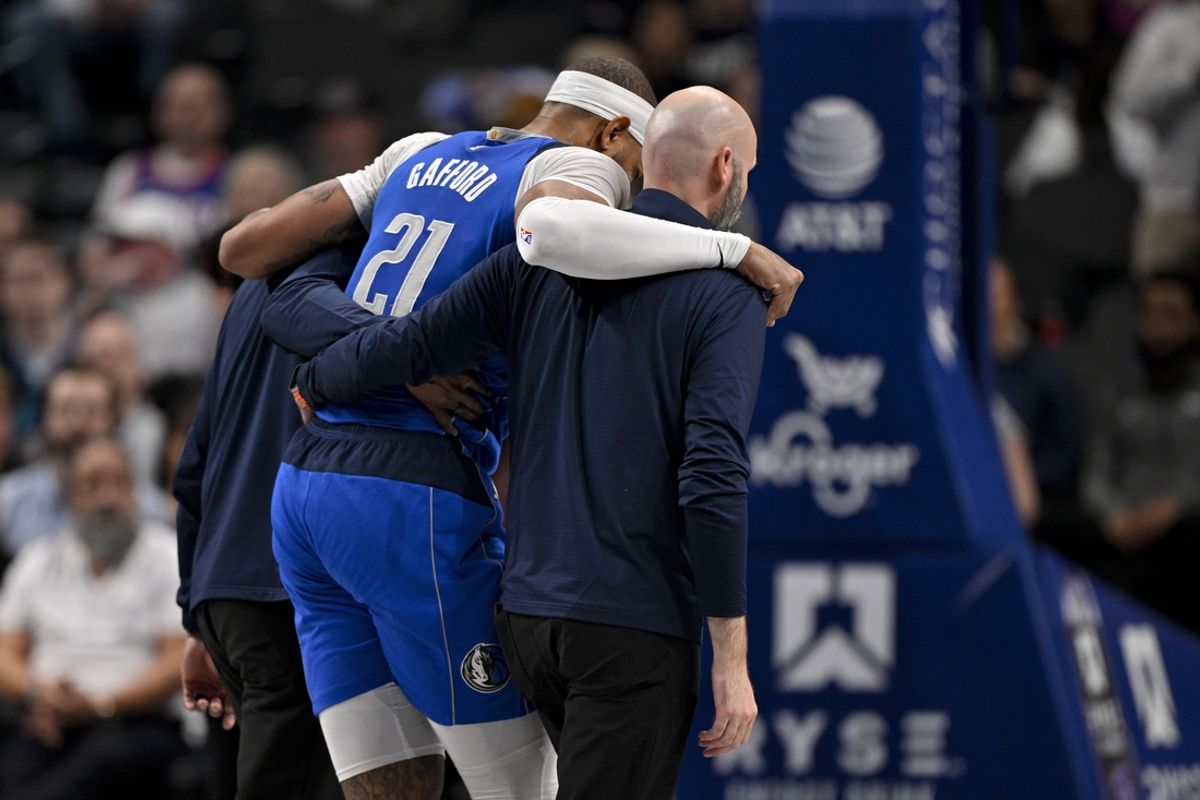 Feb 10, 2025; Dallas, Texas, USA; Dallas Mavericks center Daniel Gafford (21) is helped off the court during the second quarter against the Sacramento Kings at the American Airlines Center. Mandatory Credit: Jerome Miron-Imagn Images
