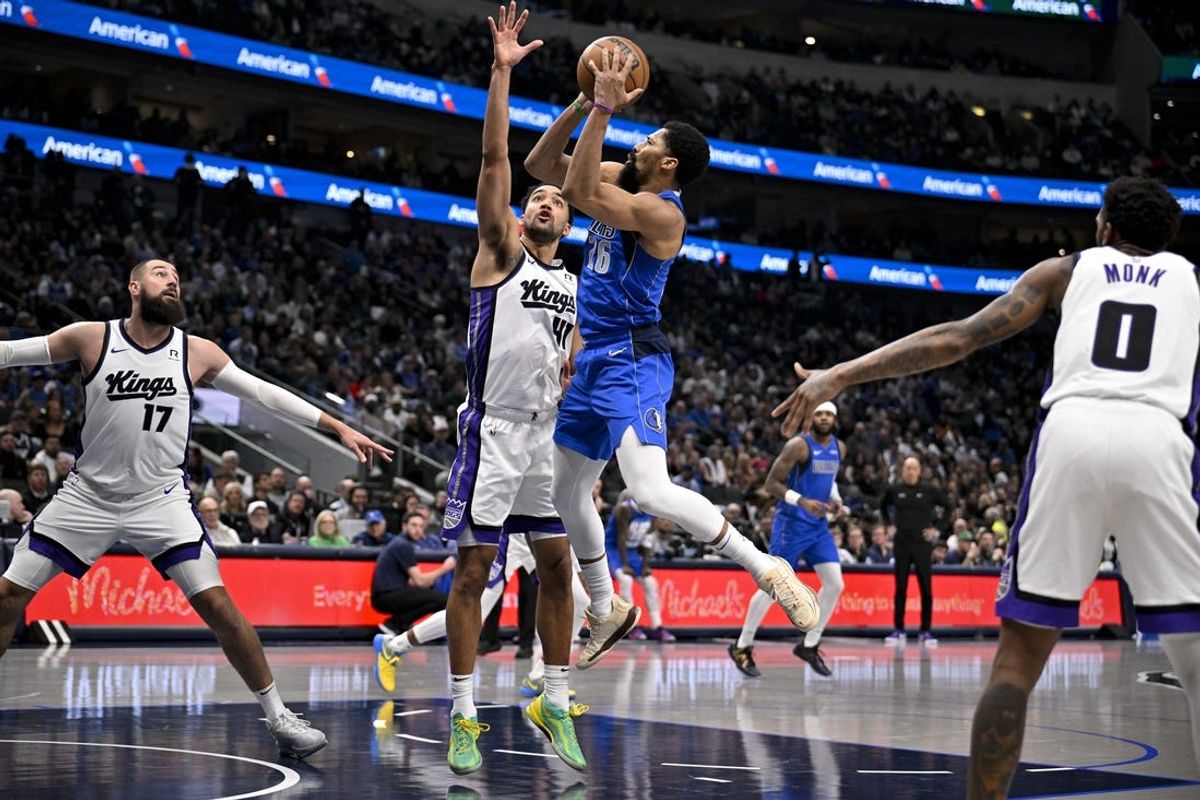 Feb 10, 2025; Dallas, Texas, USA; Dallas Mavericks guard Spencer Dinwiddie (26) shoots the ball over Sacramento Kings forward Trey Lyles (41) during the second quarter at the American Airlines Center. Mandatory Credit: Jerome Miron-Imagn Images