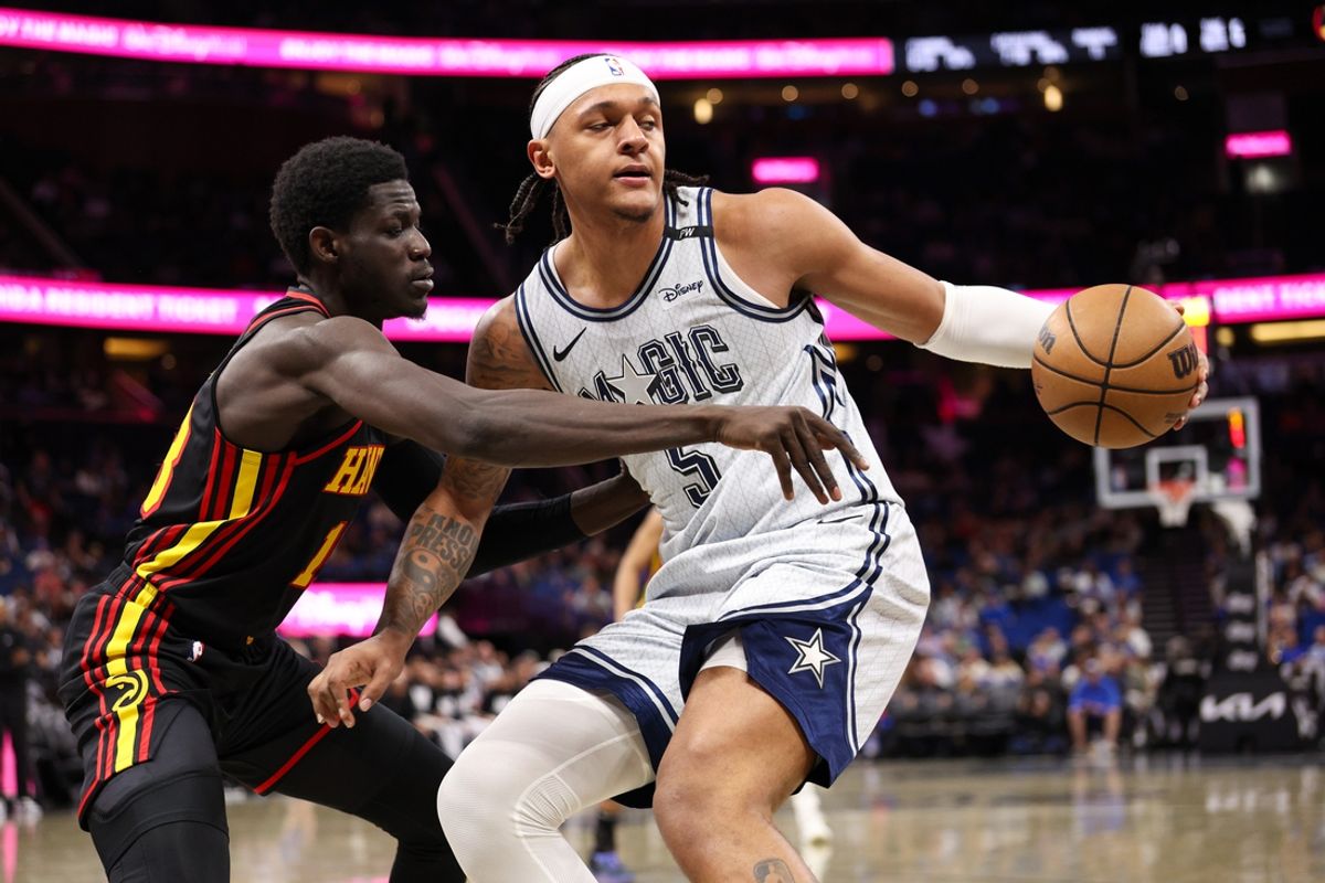 Feb 10, 2025; Orlando, Florida, USA; Orlando Magic forward Paolo Banchero (5) controls the ball from Atlanta Hawks forward Mouhamed Gueye (18) in the third quarter at Kia Center. Mandatory Credit: Nathan Ray Seebeck-Imagn Images