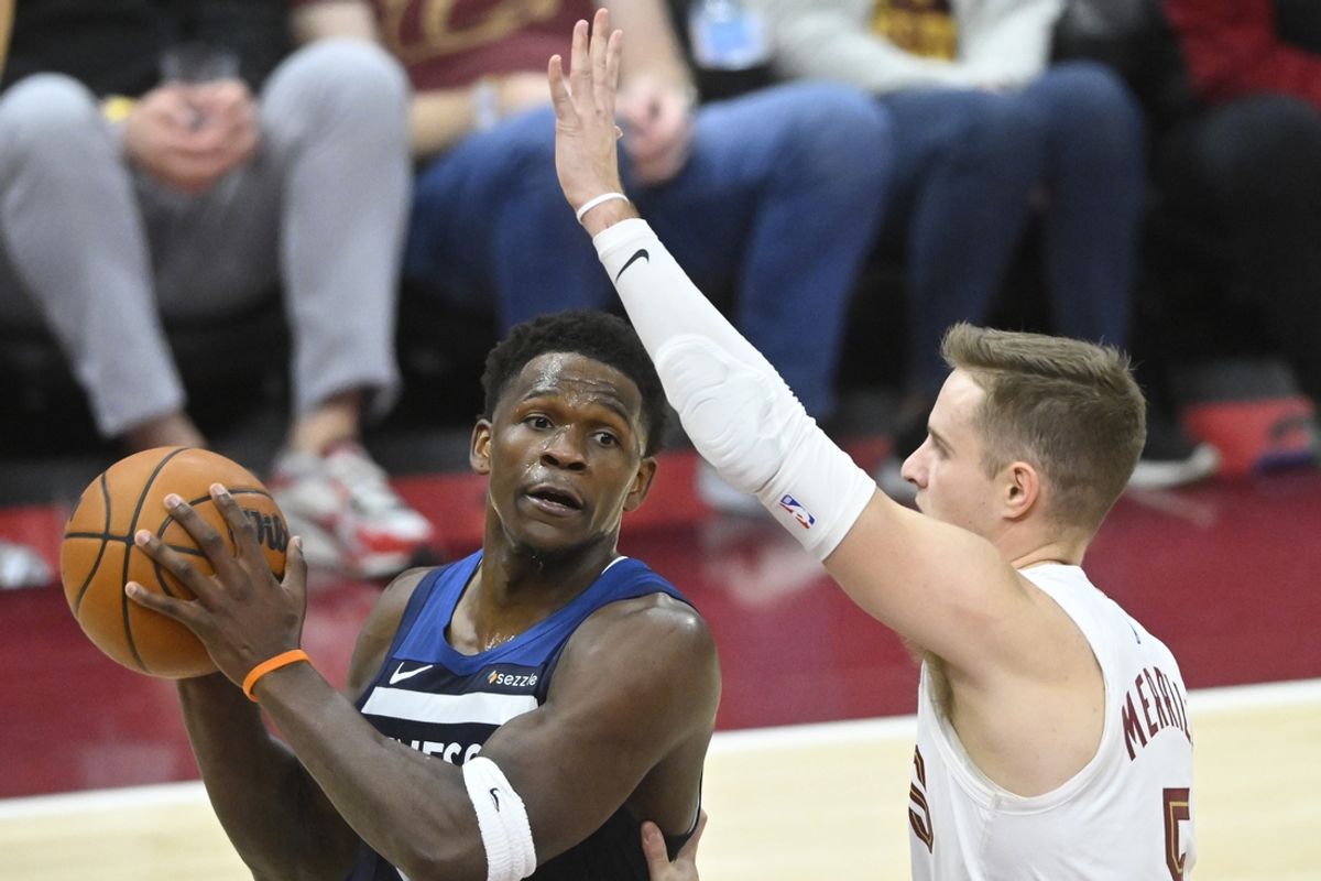 Feb 10, 2025; Cleveland, Ohio, USA; Minnesota Timberwolves guard Anthony Edwards (5) looks to pass beside Cleveland Cavaliers guard Sam Merrill (5) in the fourth quarter at Rocket Mortgage FieldHouse. Mandatory Credit: David Richard-Imagn Images