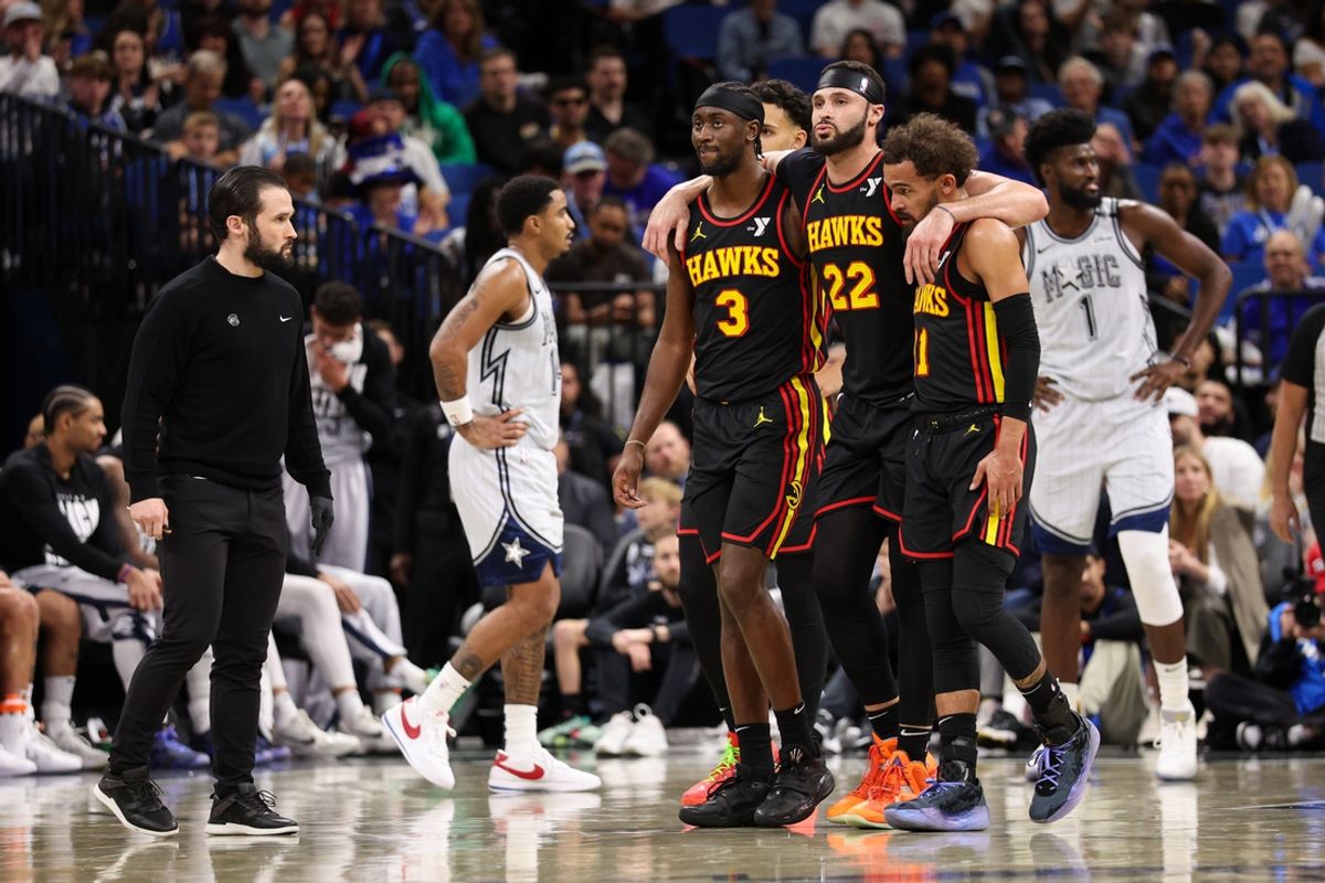 Feb 10, 2025; Orlando, Florida, USA; Atlanta Hawks forward Larry Nance Jr. (22) is helped off the court by Atlanta Hawks guard Trae Young (11) and Atlanta Hawks guard Caris LeVert (3) against the Orlando Magic in the fourth quarter at Kia Center. Mandatory Credit: Nathan Ray Seebeck-Imagn Images