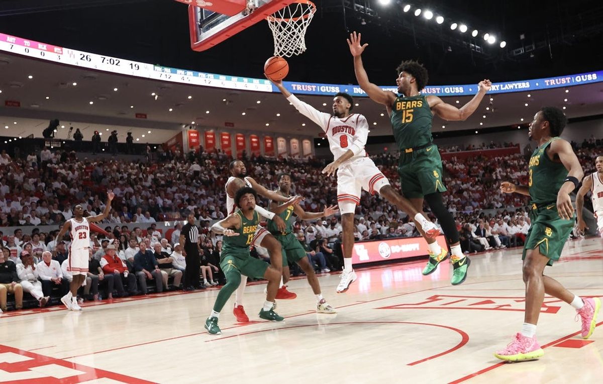 Feb 10, 2025; Houston, Texas, USA; Houston Cougars guard Mylik Wilson (8) scores against the Baylor Bears forward Norchad Omier (15) in the first half at Fertitta Center. Mandatory Credit: Thomas Shea-Imagn Images
