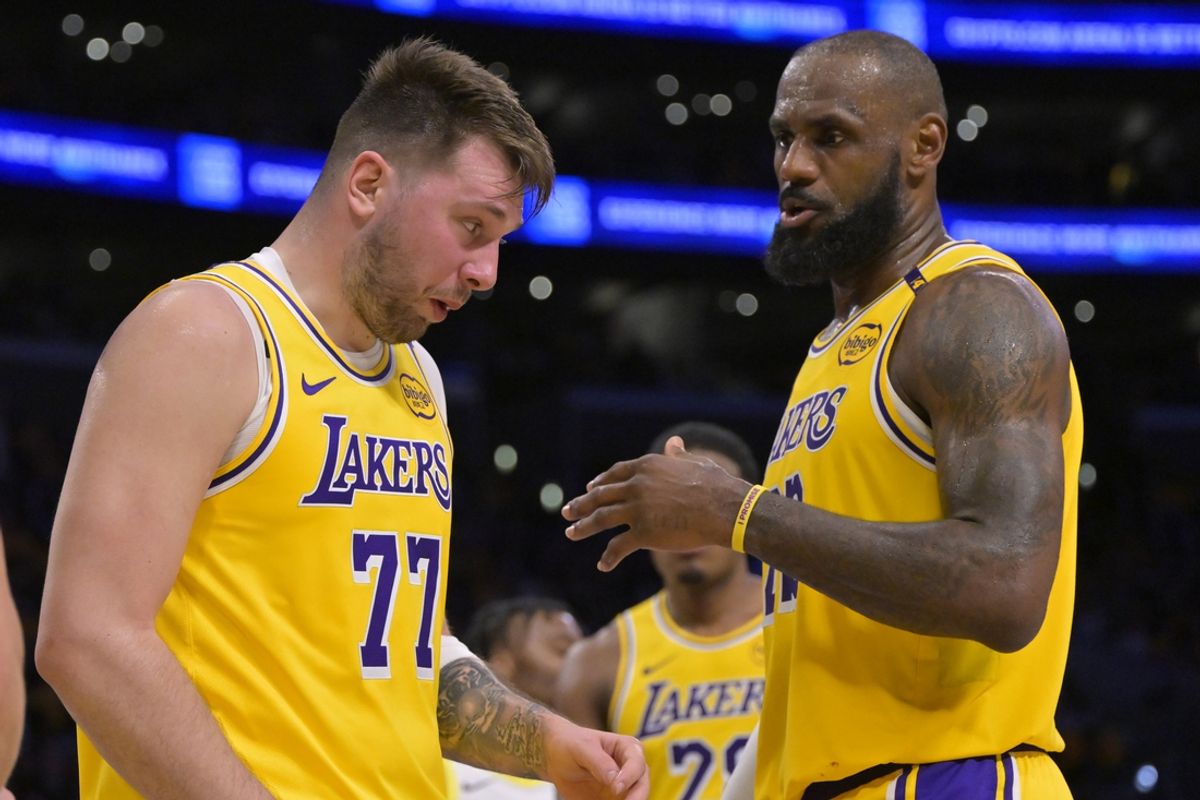 Feb 10, 2025; Los Angeles, California, USA; Los Angeles Lakers forward LeBron James (23) checks on guard Luka Doncic (77) after he was hit in the face against the Utah Jazz at Crypto.com Arena. Mandatory Credit: Jayne Kamin-Oncea-Imagn Images