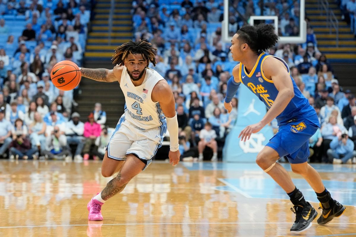 Feb 8, 2025; Chapel Hill, North Carolina, USA; North Carolina Tar Heels guard RJ Davis (4) with the ball as Pittsburgh Panthers guard Jaland Lowe (15) defends in the second half at Dean E. Smith Center. Mandatory Credit: Bob Donnan-Imagn Images