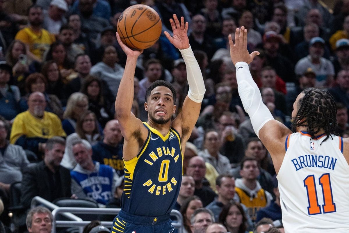 Feb 11, 2025; Indianapolis, Indiana, USA; Indiana Pacers guard Tyrese Haliburton (0) shoots the ball while New York Knicks guard Jalen Brunson (11) defends in the first half at Gainbridge Fieldhouse. Mandatory Credit: Trevor Ruszkowski-Imagn Images