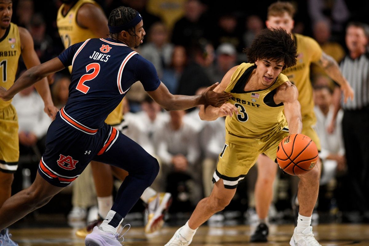 Feb 11, 2025; Nashville, Tennessee, USA;  Auburn Tigers guard Denver Jones (2) grabs the jersey of Vanderbilt Commodores guard Tyler Tanner (3) during the first half at Memorial Gymnasium. Mandatory Credit: Steve Roberts-Imagn Images