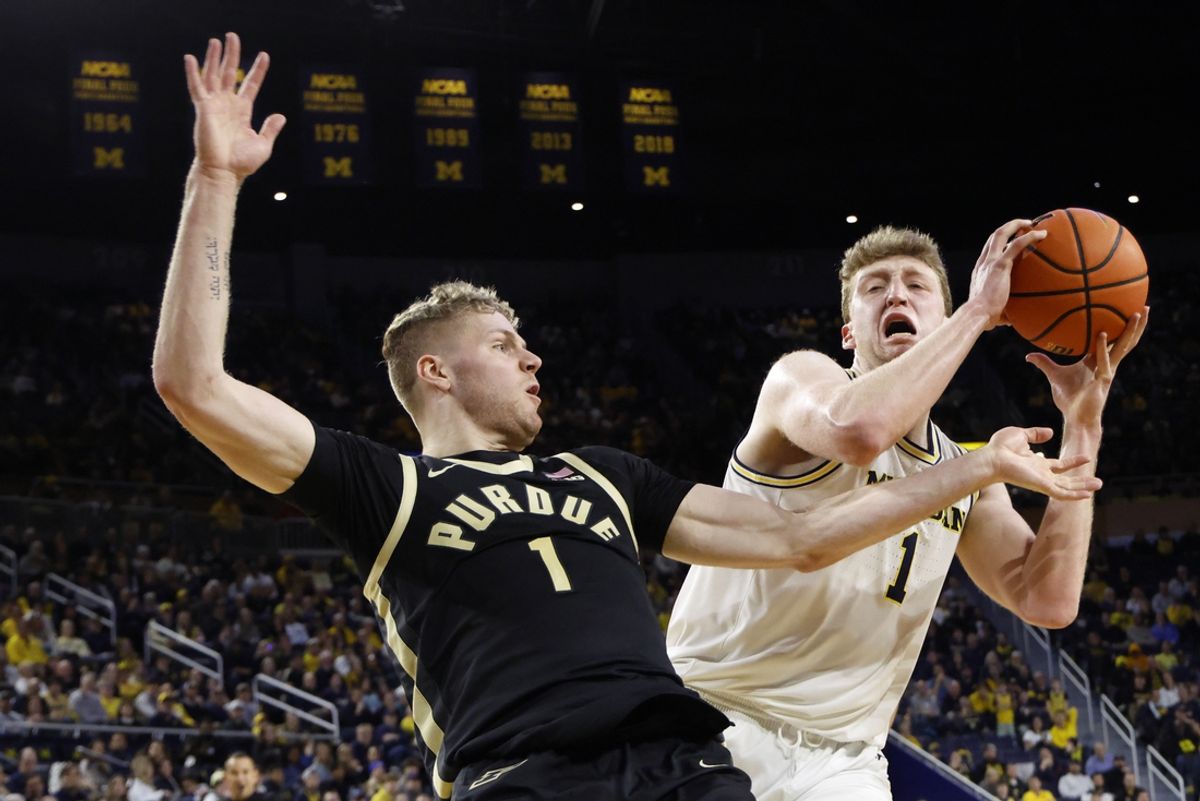 Feb 11, 2025; Ann Arbor, Michigan, USA;  Michigan Wolverines center Danny Wolf (1) is defended by Purdue Boilermakers forward Caleb Furst (1) in the first half at Crisler Center. Mandatory Credit: Rick Osentoski-Imagn Images