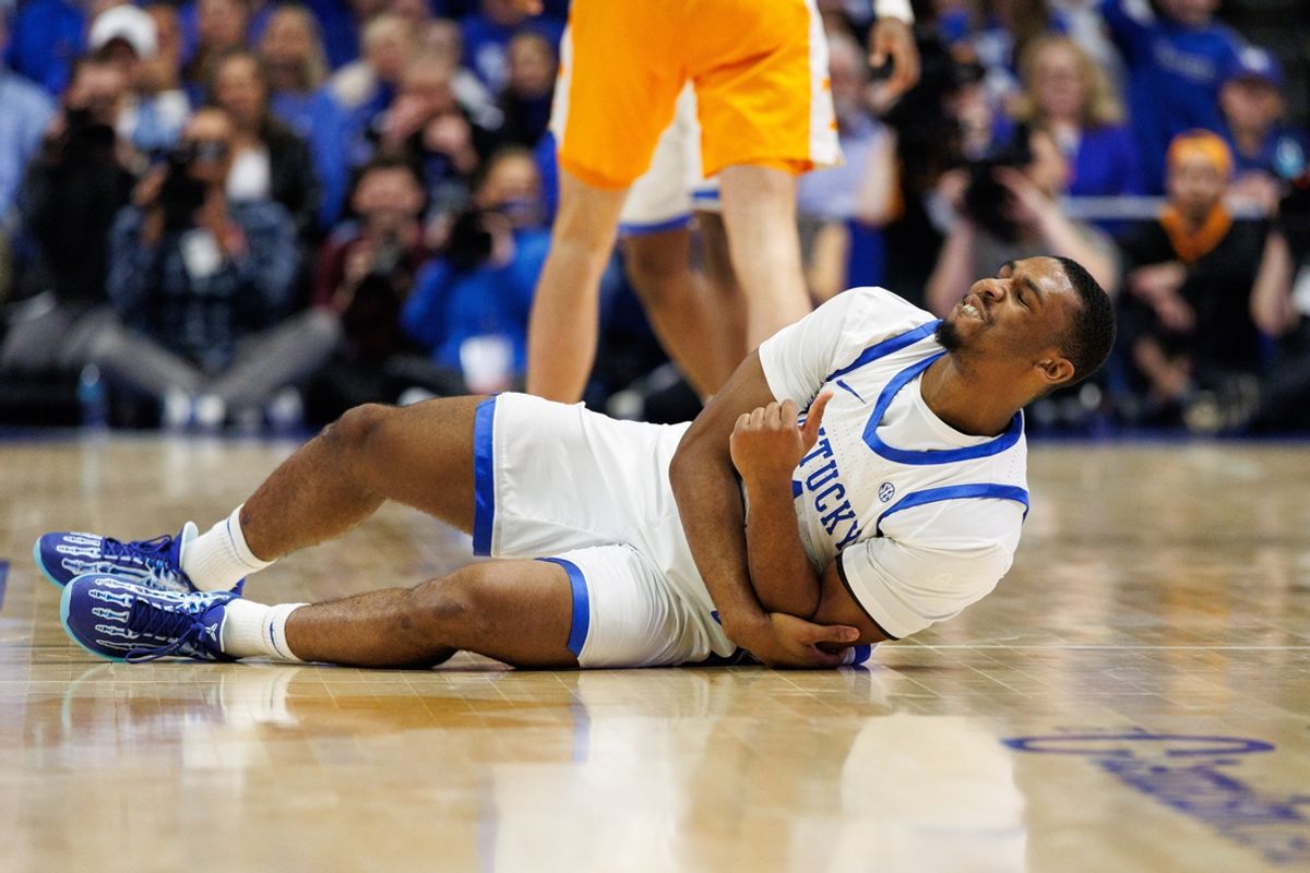 Feb 11, 2025; Lexington, Kentucky, USA; Kentucky Wildcats guard Lamont Butler (1) falls to the court holding his arm during the second half against the Tennessee Volunteers at Rupp Arena at Central Bank Center. Mandatory Credit: Jordan Prather-Imagn Images