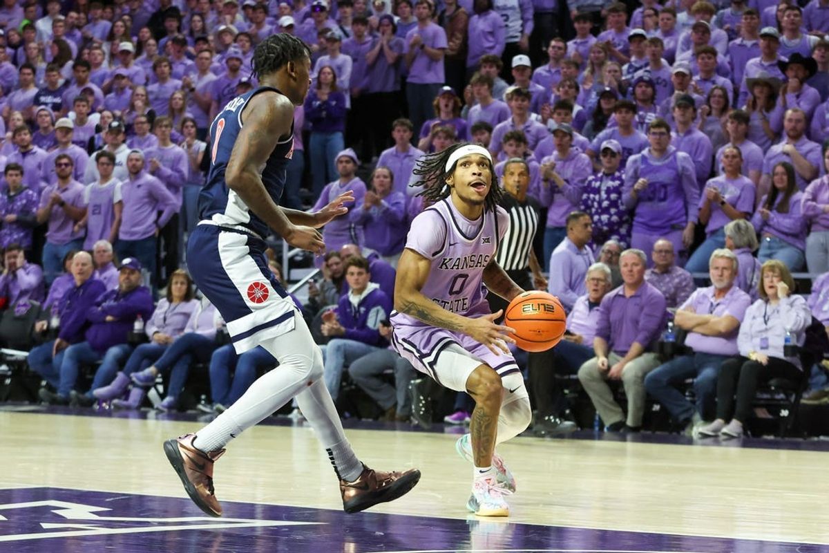 Feb 11, 2025; Manhattan, Kansas, USA; Kansas State Wildcats guard Dug McDaniel (0) drives to the basket against Arizona Wildcats guard Jaden Bradley (0) during the first half at Bramlage Coliseum. Mandatory Credit: Scott Sewell-Imagn Images