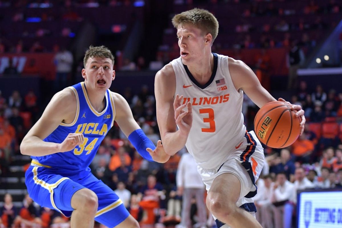 Feb 11, 2025; Champaign, Illinois, USA;  Illinois Fighting Illini forward Ben Humrichous (3) drives the ball past UCLA Bruins forward Tyler Bilodeau (34) during the first half at State Farm Center. Mandatory Credit: Ron Johnson-Imagn Images