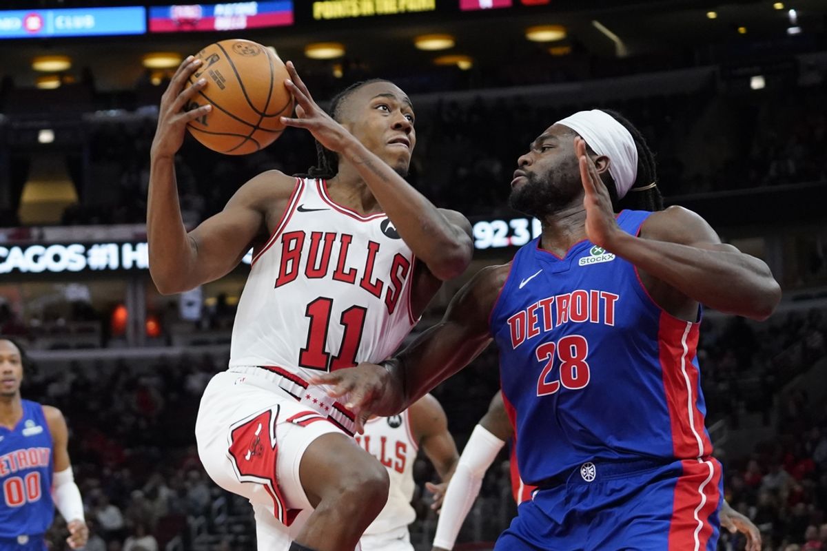 Feb 11, 2025; Chicago, Illinois, USA; Detroit Pistons center Isaiah Stewart (28) defends Chicago Bulls guard Ayo Dosunmu (11) during the first quarter at United Center. Mandatory Credit: David Banks-Imagn Images