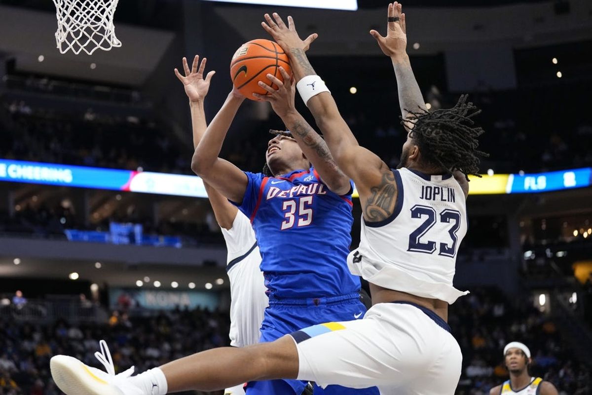 Feb 11, 2025; Milwaukee, Wisconsin, USA;  DePaul Blue Demons forward NJ Benson (35) shoots against Marquette Golden Eagles forward David Joplin (23) during the first half at Fiserv Forum. Mandatory Credit: Jeff Hanisch-Imagn Images