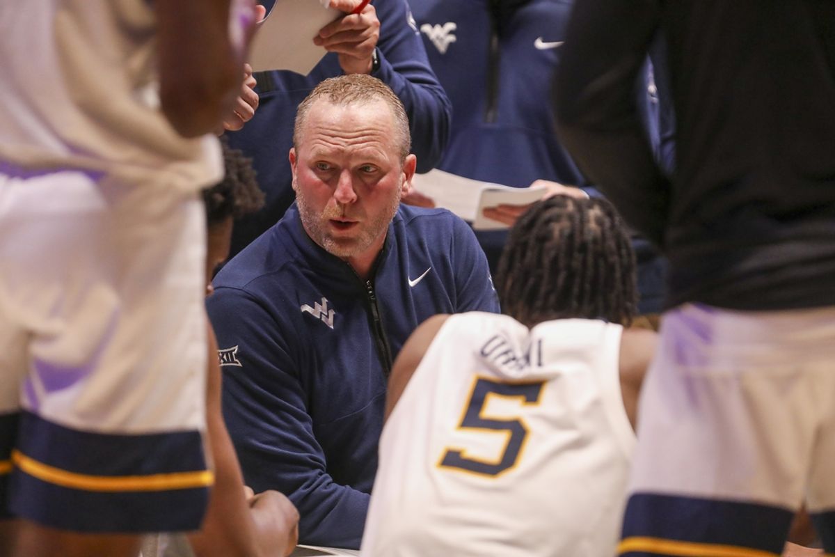 Feb 11, 2025; Morgantown, West Virginia, USA; West Virginia Mountaineers head coach Darian DeVries talks to his team during the second half against the Brigham Young Cougars at WVU Coliseum. Mandatory Credit: Ben Queen-Imagn Images